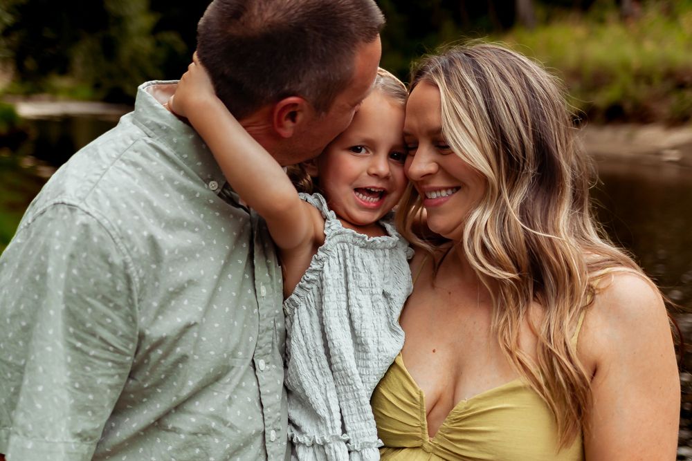 An intimate family moment captured outdoors in natural lighting. Denver Family Photography.