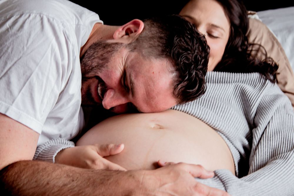 Intimate maternity moment showing connection with growing belly. Denver Family Photography.
