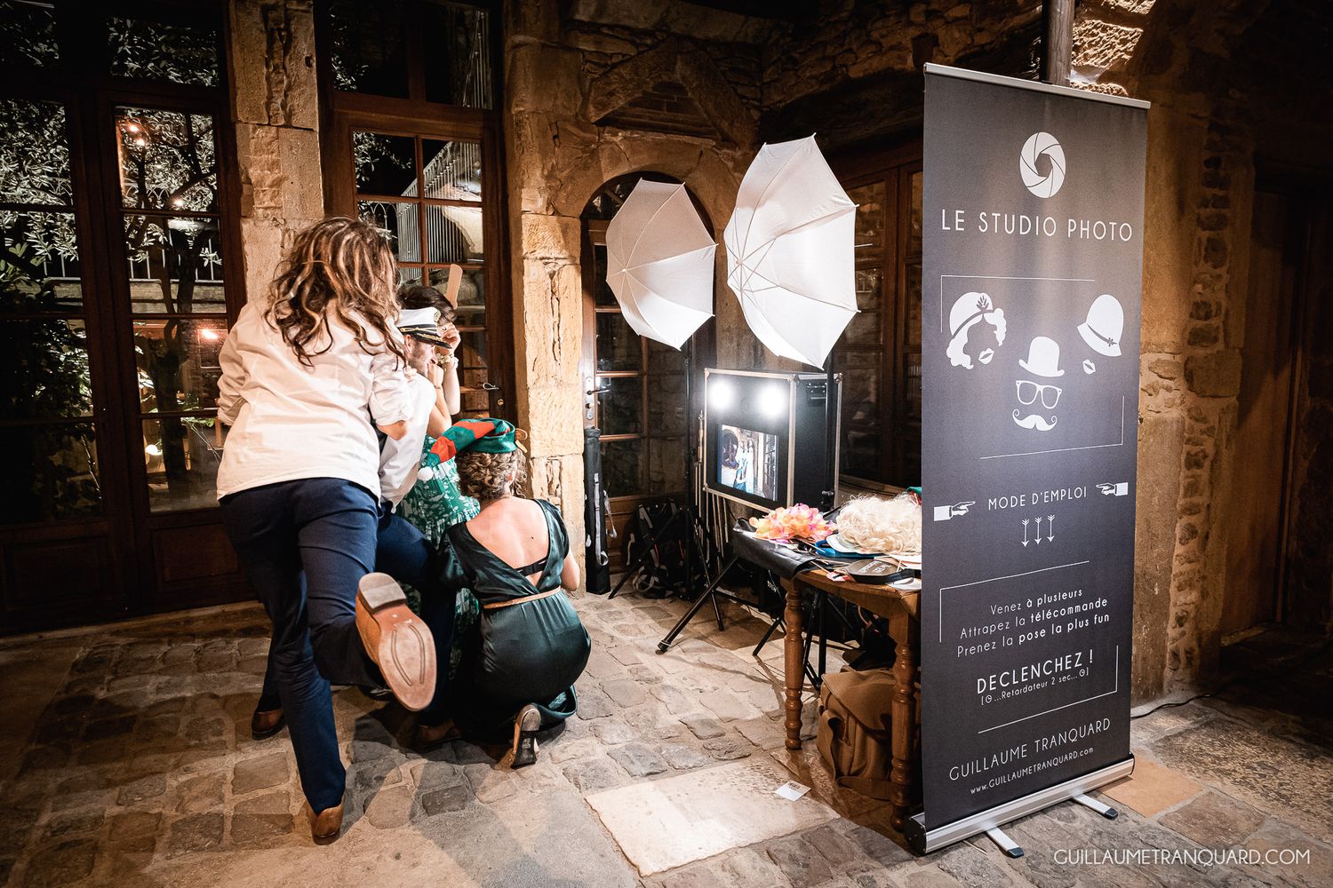 Interior shots of a rustic stone venue with elegant lighting and signage.
