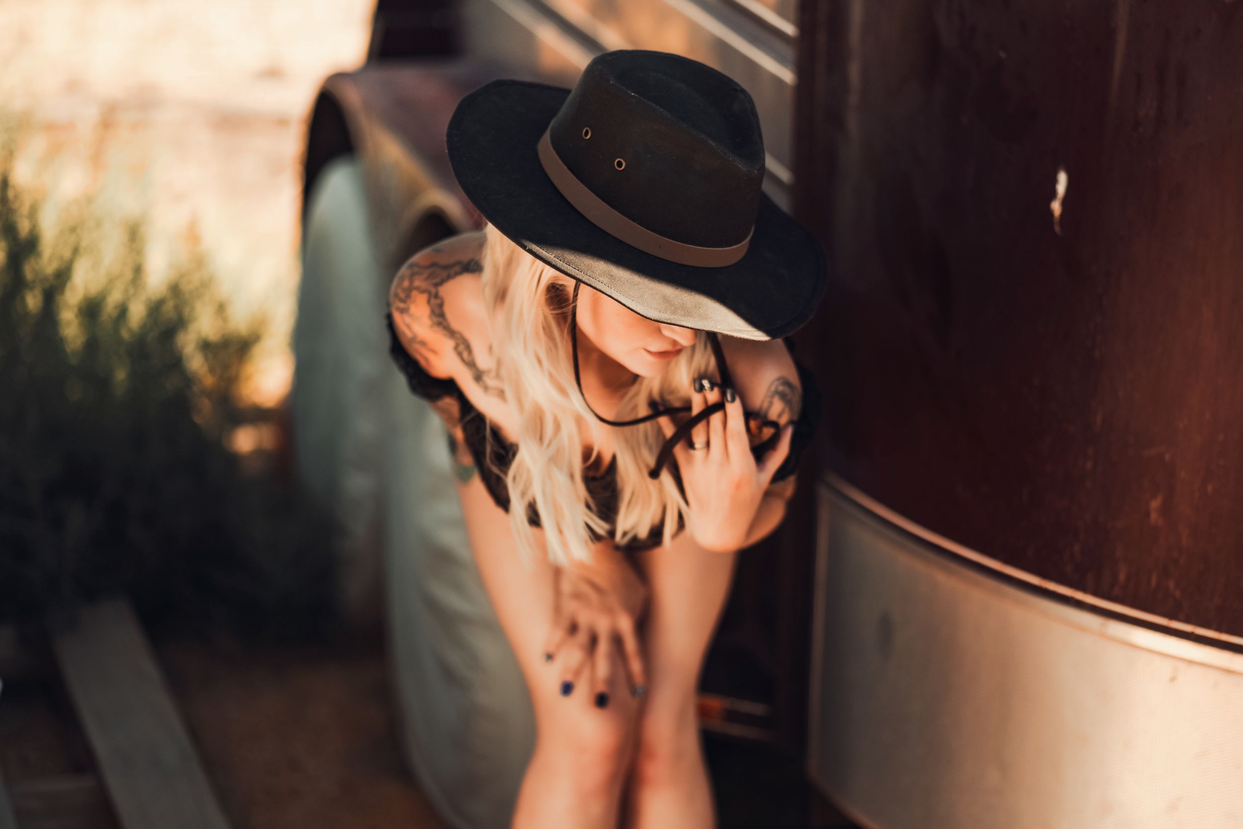 Cowgirl posing in front of a horse trailer