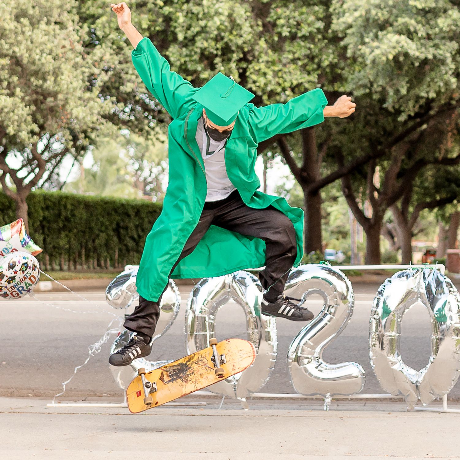 Graduation skateboarding guy