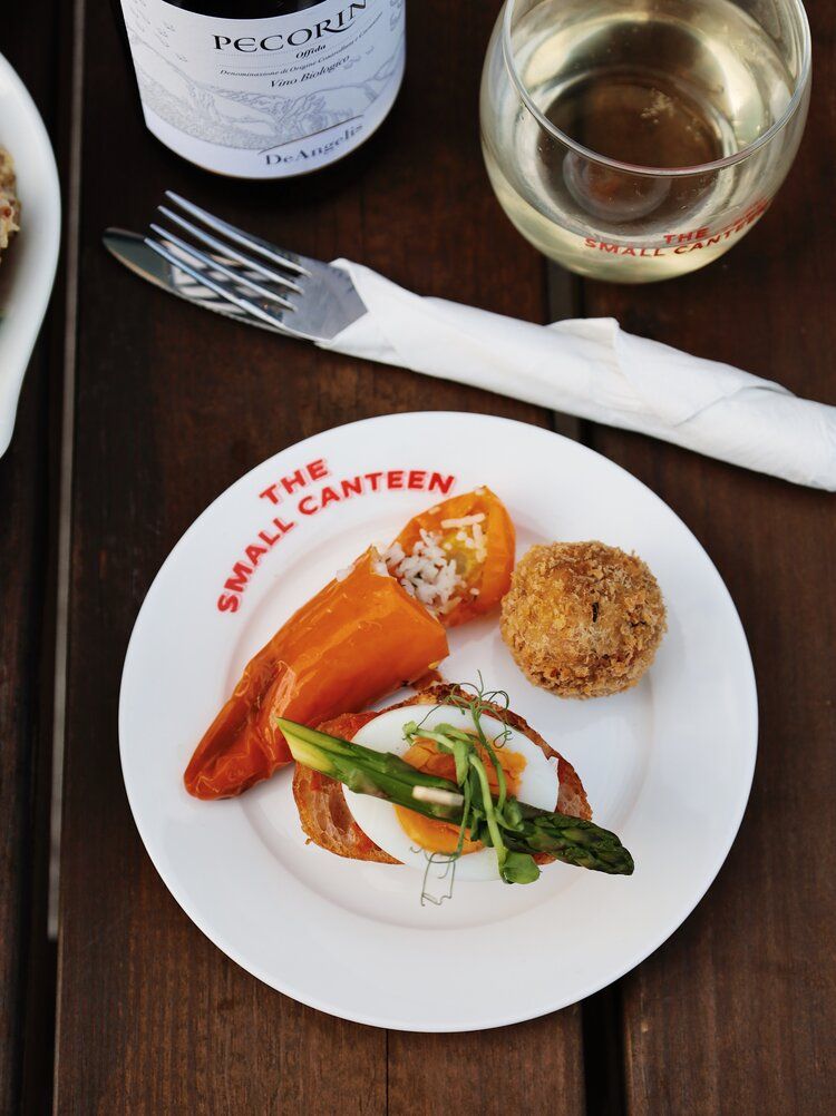 Restaurant plates with seafood and garnishes served on a dark wooden table.