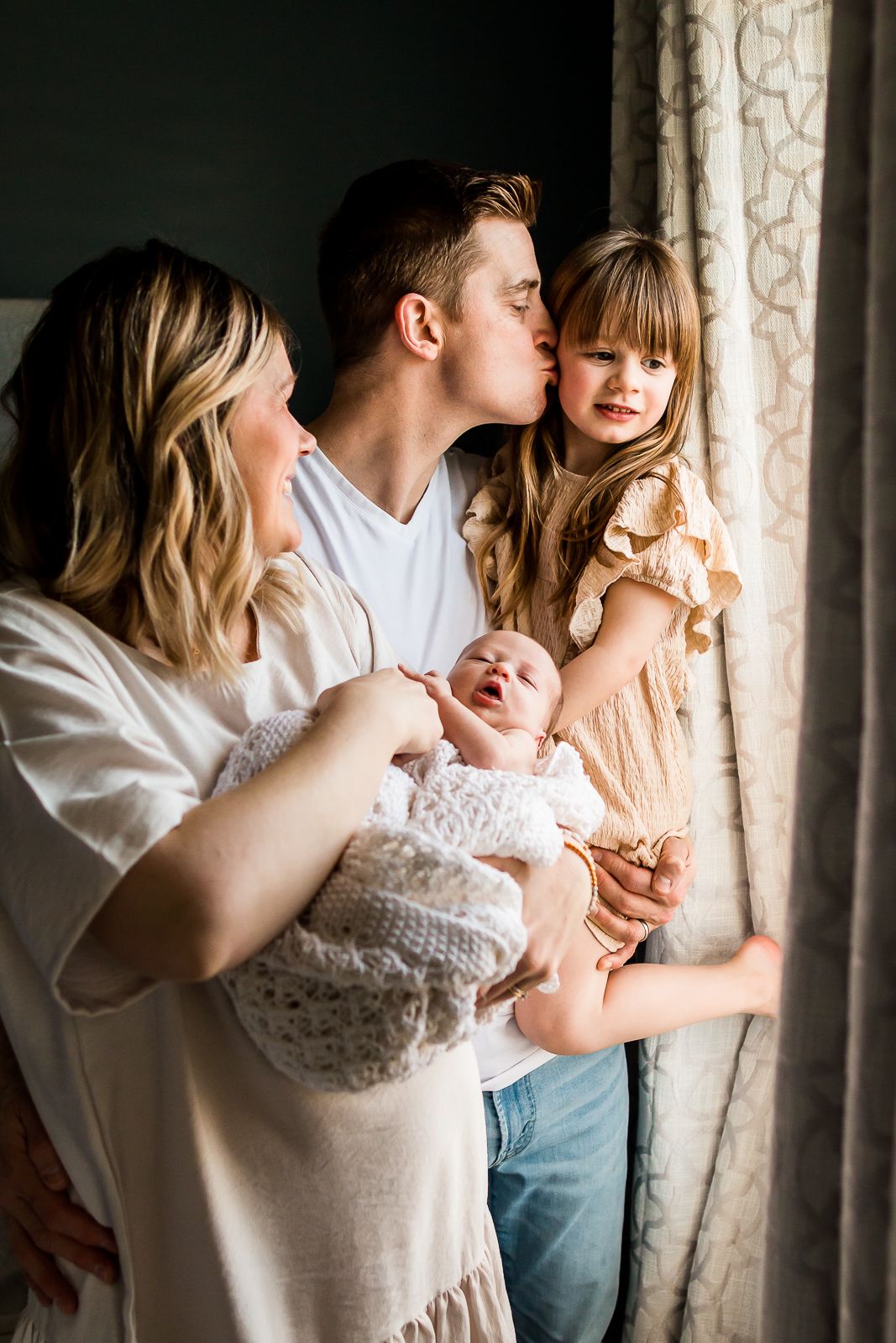 Beautiful family welcoming new baby during a lifestyle newborn session in Calgary AB.