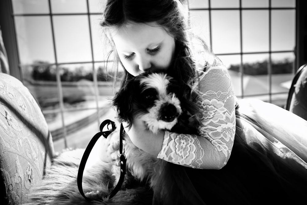 Black and white photo of tender embraces during wedding preparations.