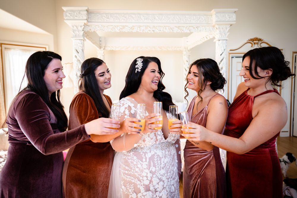Wedding party celebrates with champagne toasts in elegant venue.