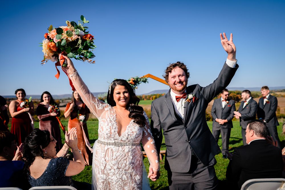Wedding celebration outdoors with joyful moments captured against bright blue sky.
