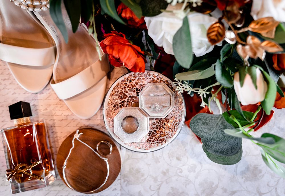 Wedding decor featuring floral arrangements with red and peach roses.