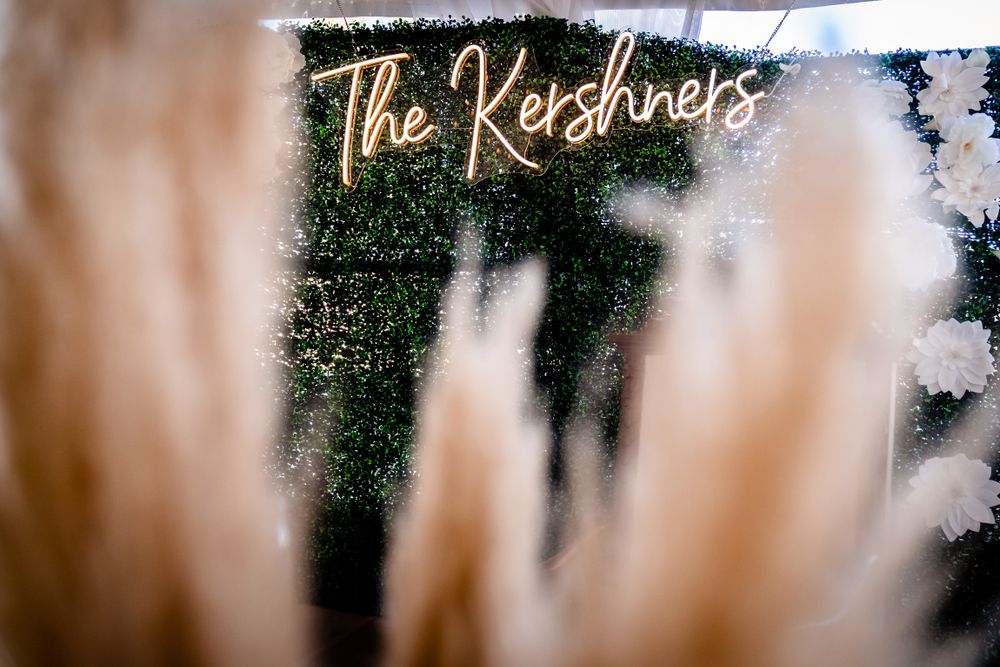 Wedding decor featuring illuminated signage and elegant floral arrangements.