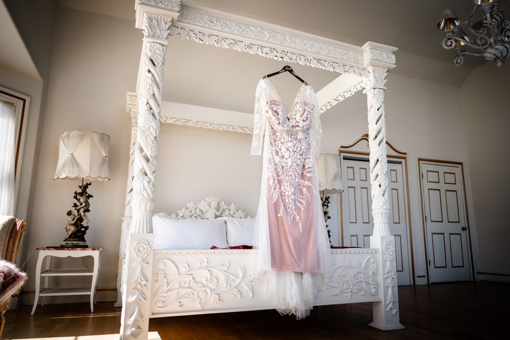 Wedding dress and decor displayed in bright white room with natural light.