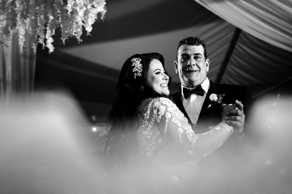 Black and white wedding reception detail shot with hanging decorative elements.
