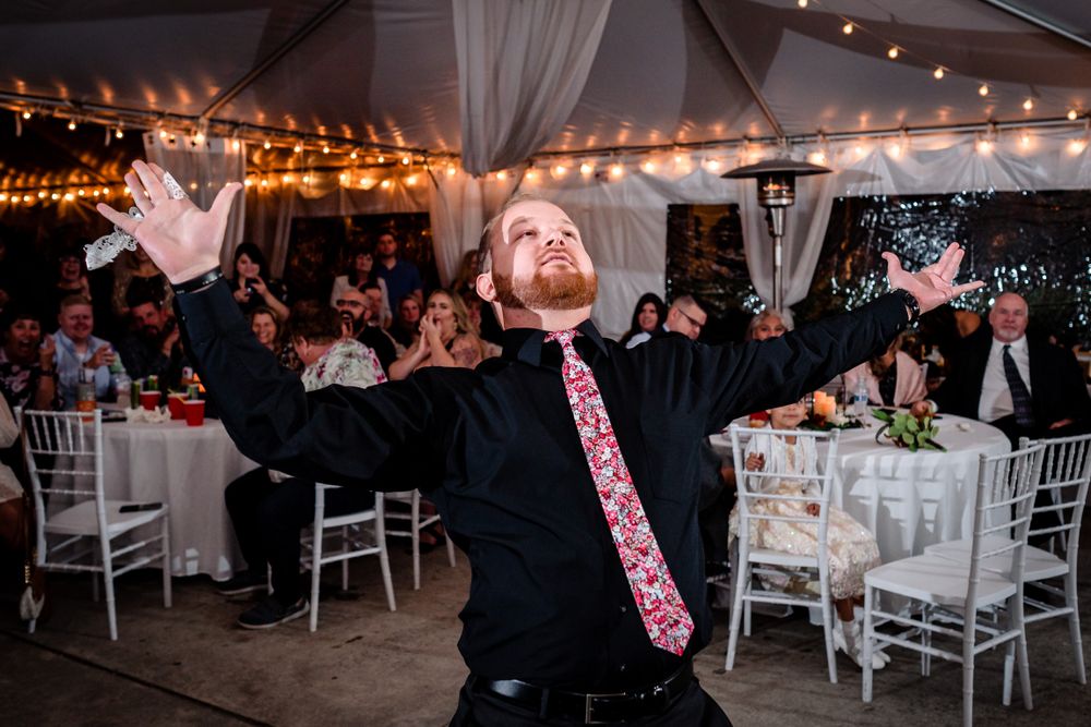 Wedding reception dance party with string lights illuminating guests on the dance floor.