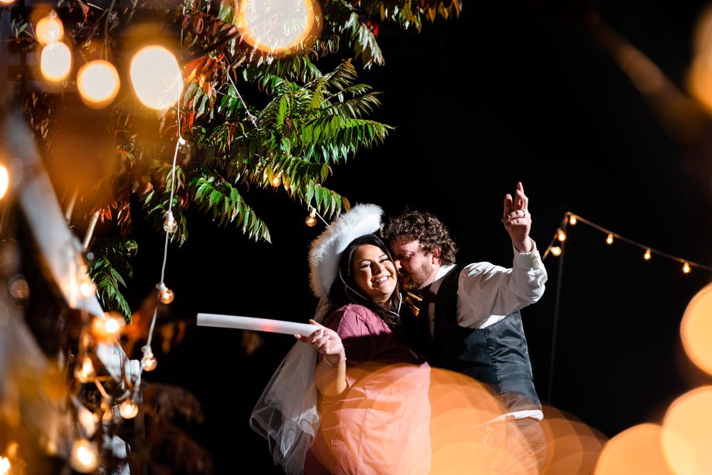 Nighttime wedding reception with glowing lights creating a magical atmosphere.