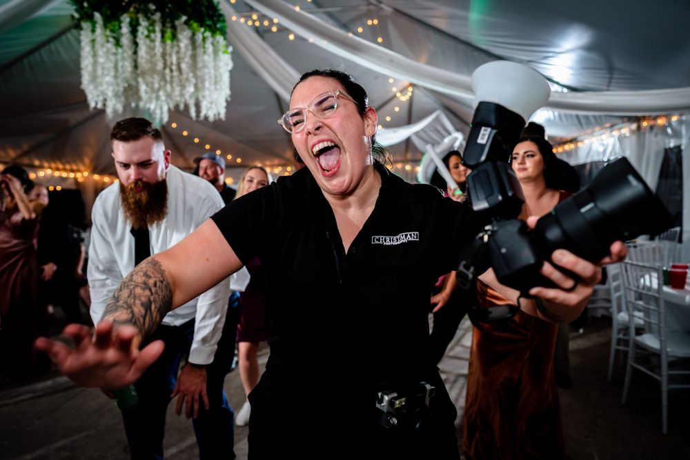 Energetic dance floor moments captured during a nighttime wedding reception celebration.