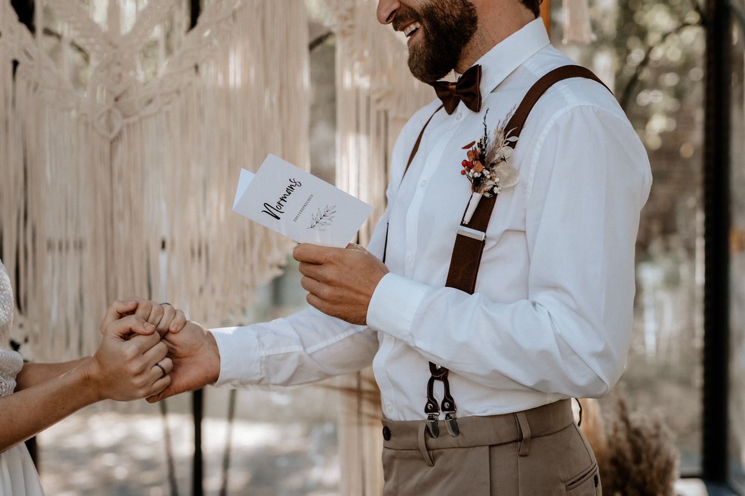 Couple exchanging rings during intimate wedding ceremony.