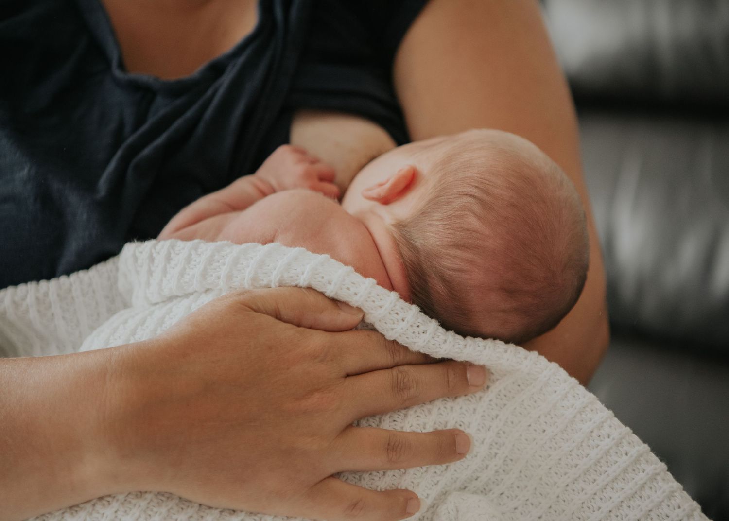 New born at home photo shoot with Cornwall new born photographer mum breastfeeding baby