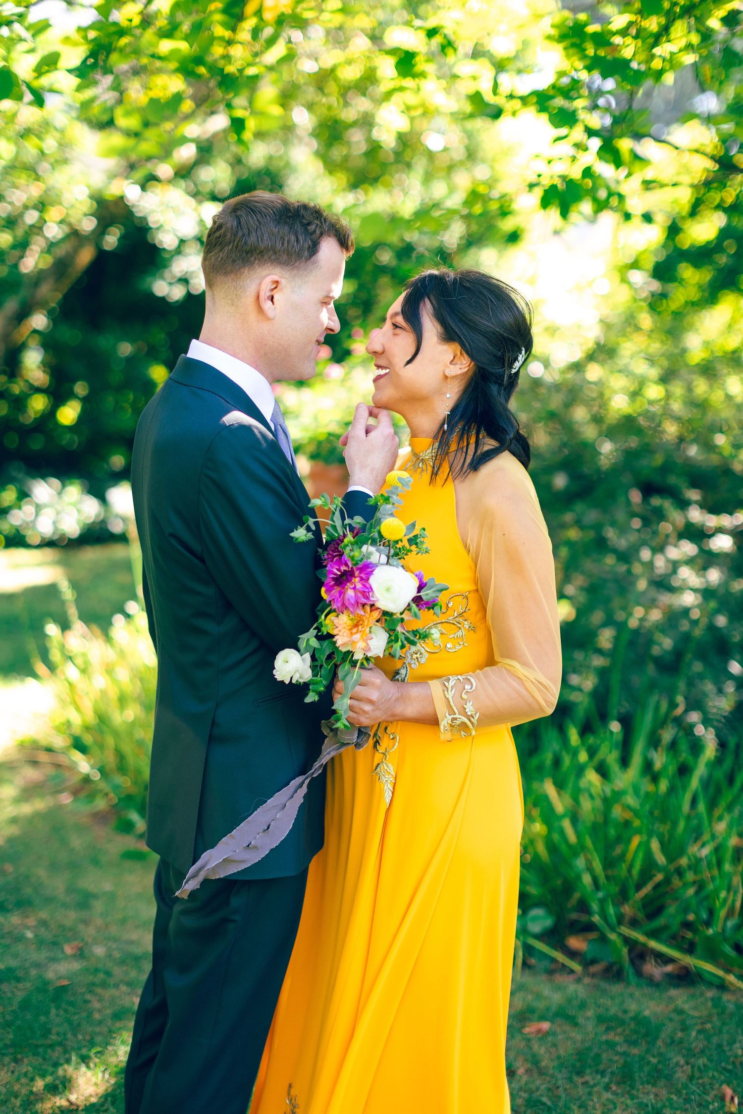 Garden wedding photography featuring bright yellow dress and colorful bouquet.