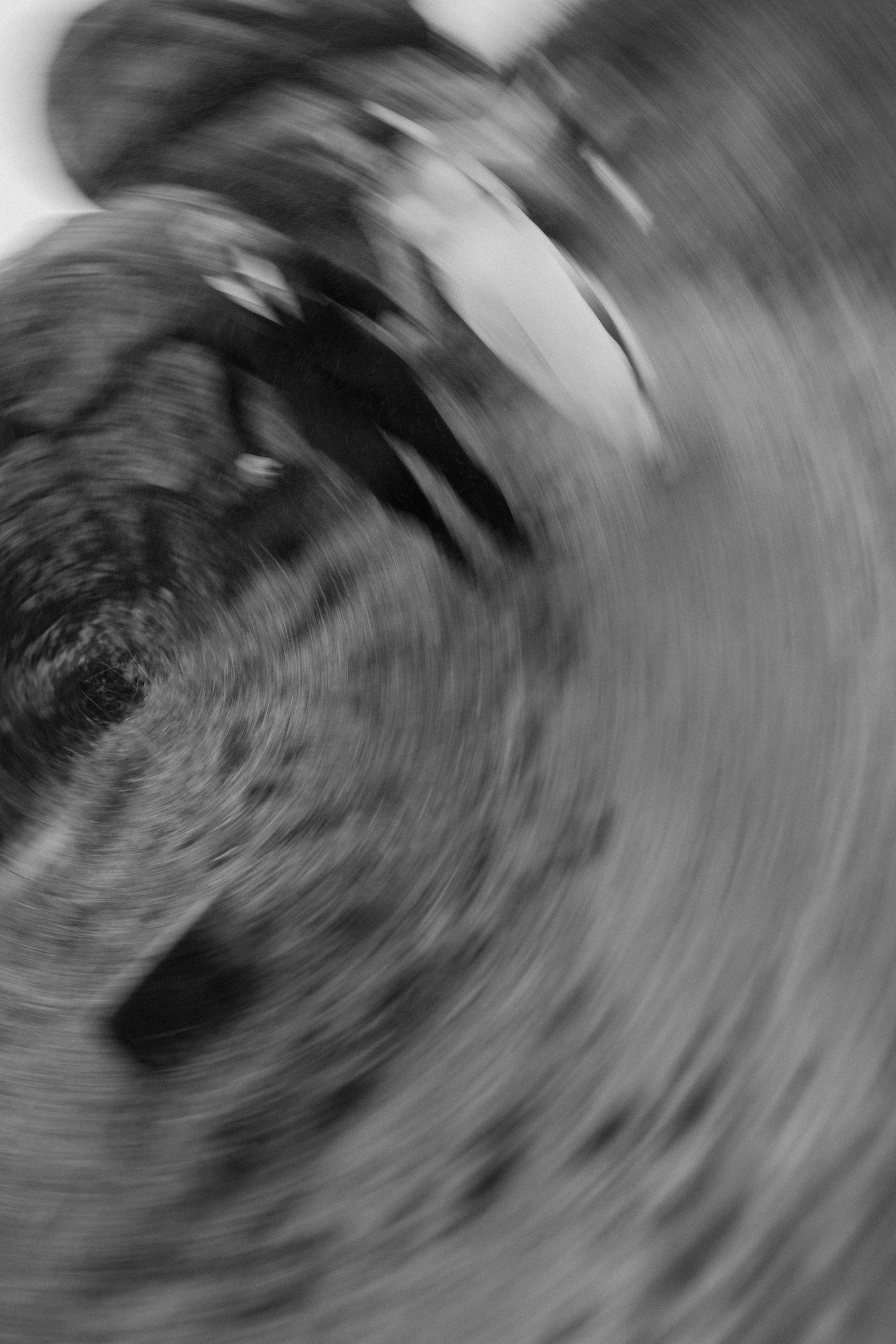 Abstract black and white photograph showing motion blur and swirling patterns.