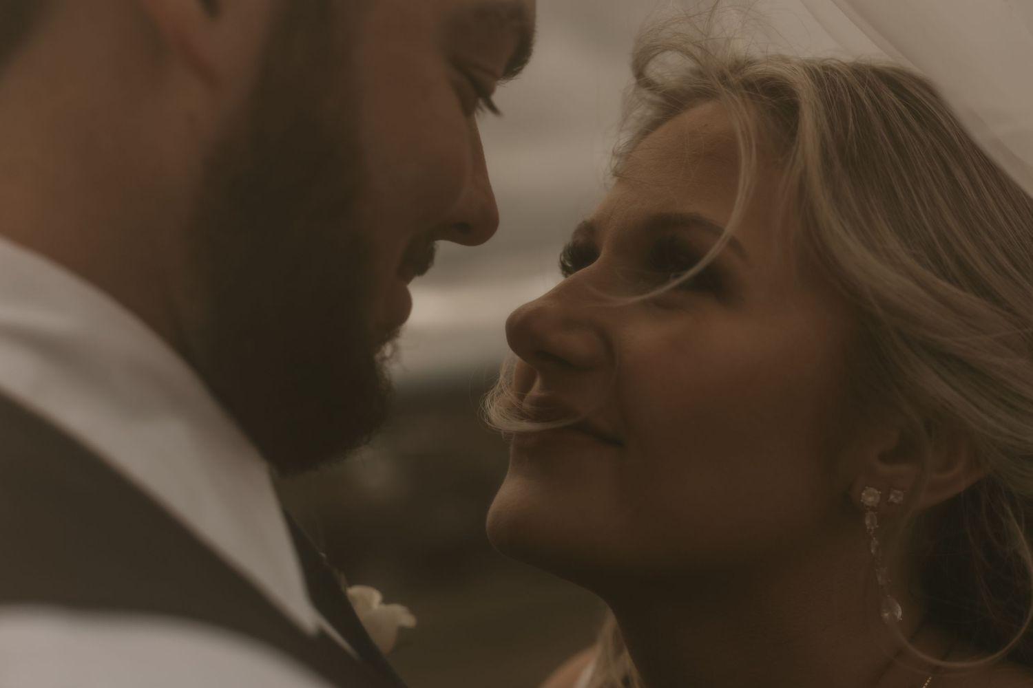 Intimate close-up wedding portrait with soft lighting and romantic atmosphere.