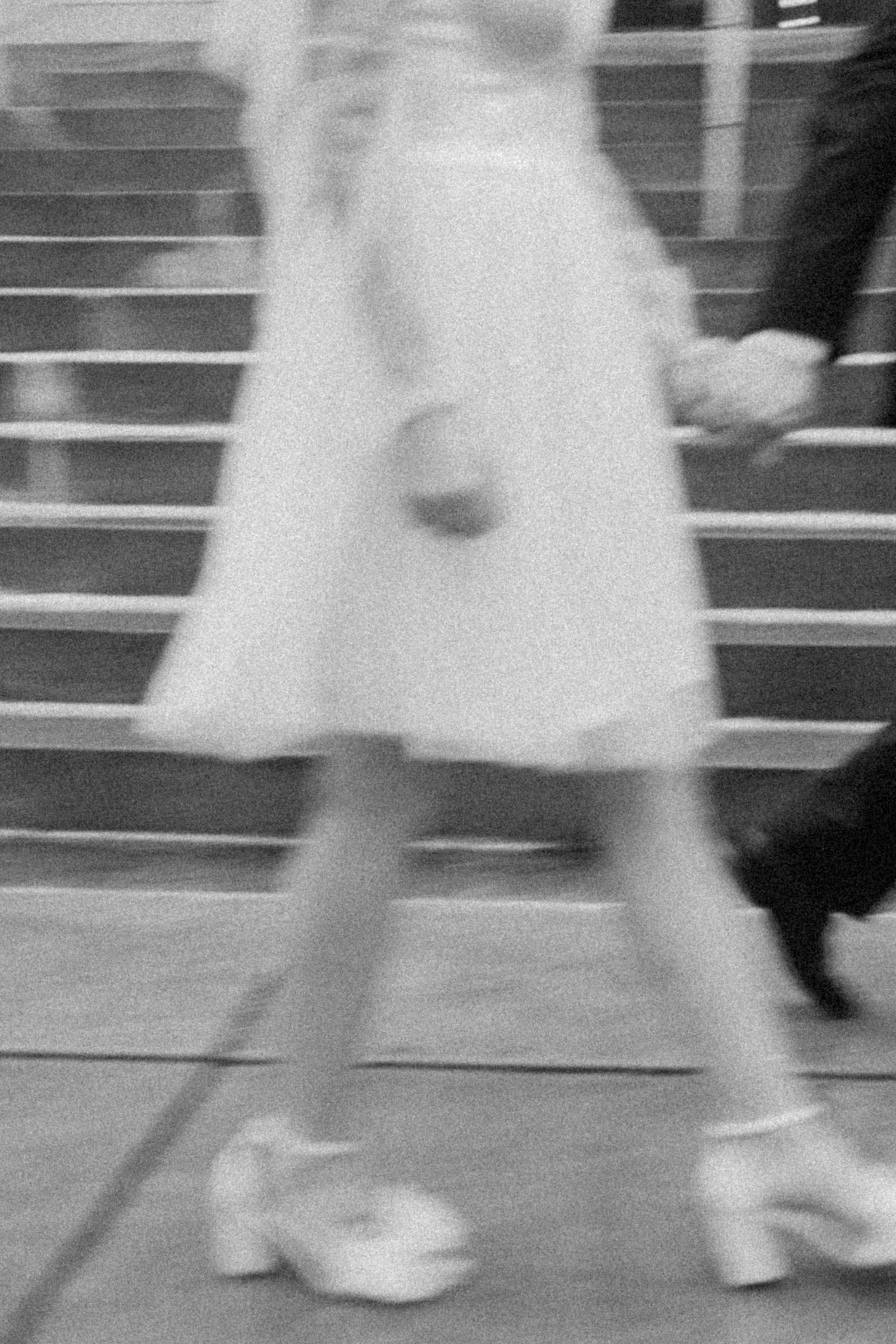Blurred vintage photo of white shoes and dress on stairs.