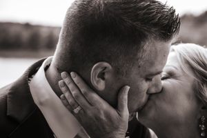 An intimate black and white close-up portrait of a romantic moment between two people.