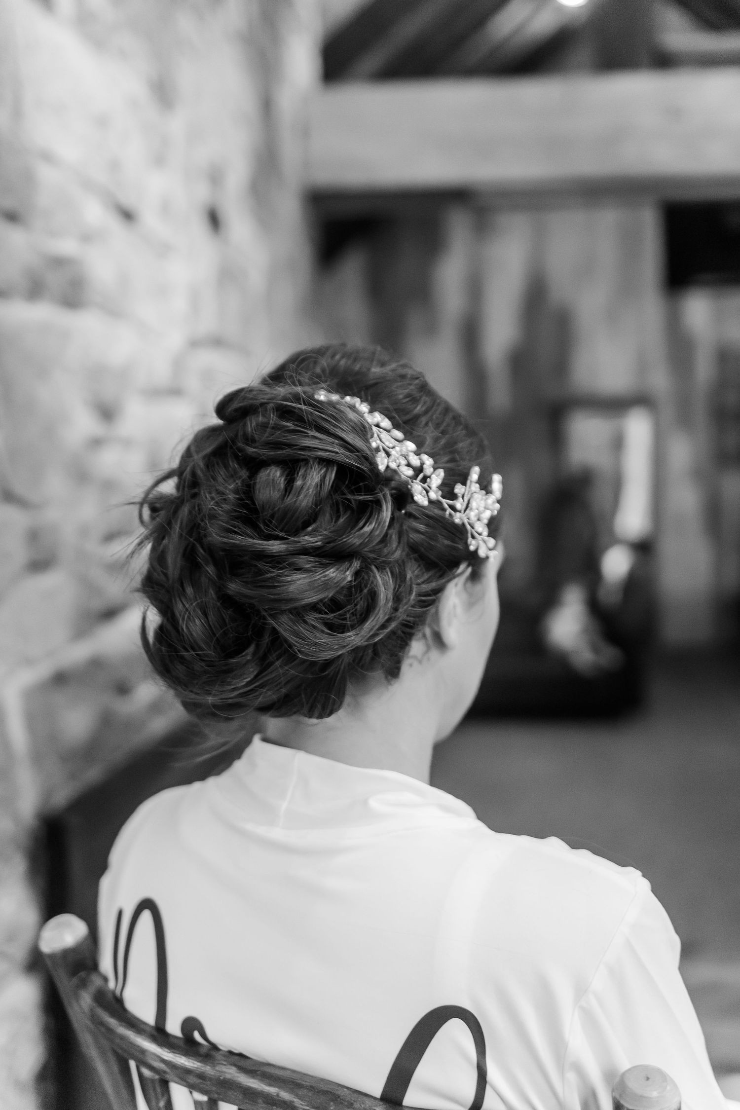 Back view of wedding party members wearing custom white getting-ready robes.