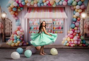 Seafoam green dress spins gracefully against a pastel storefront with balloon arch decorations.