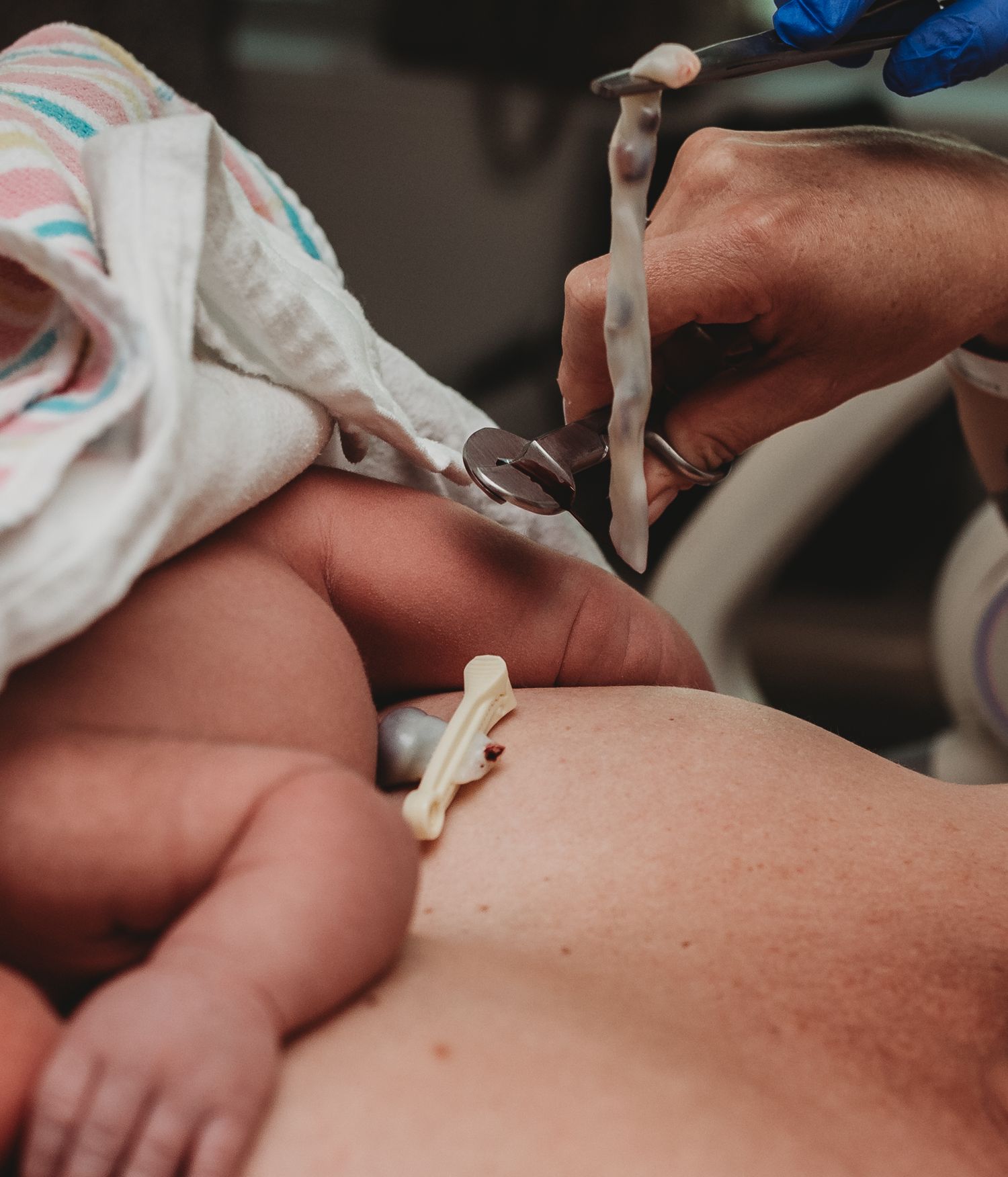 Medical professional performing newborn health screening procedures.