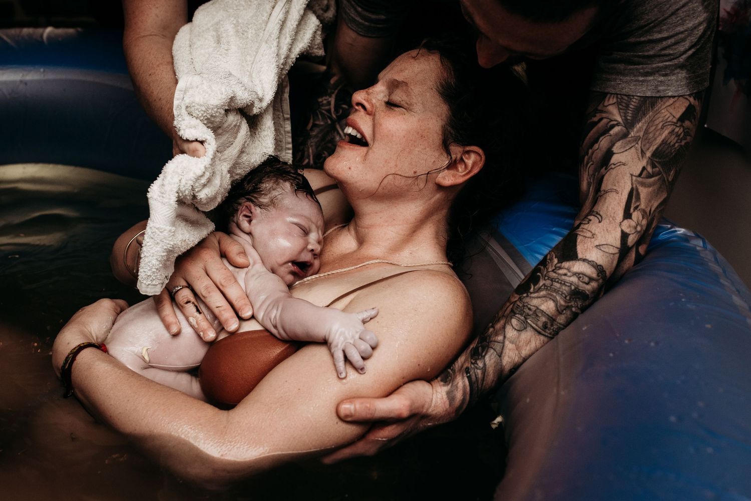 Tender moments captured in dim lighting during medical care.