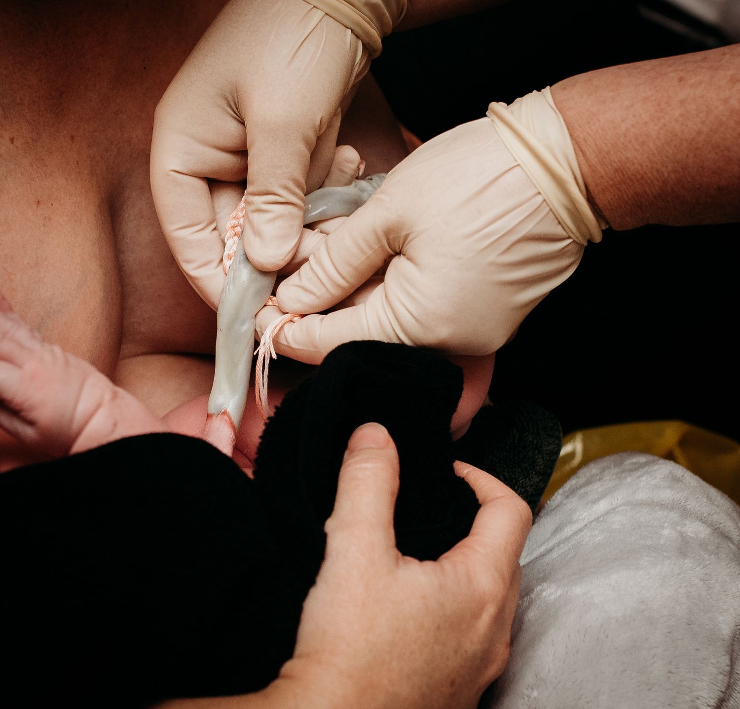 Close-up of hands during newborn medical examination.