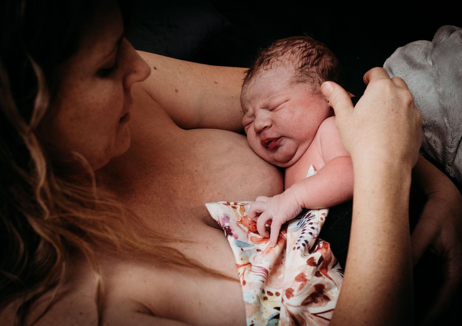 Newborn receiving gentle care during medical check-up.