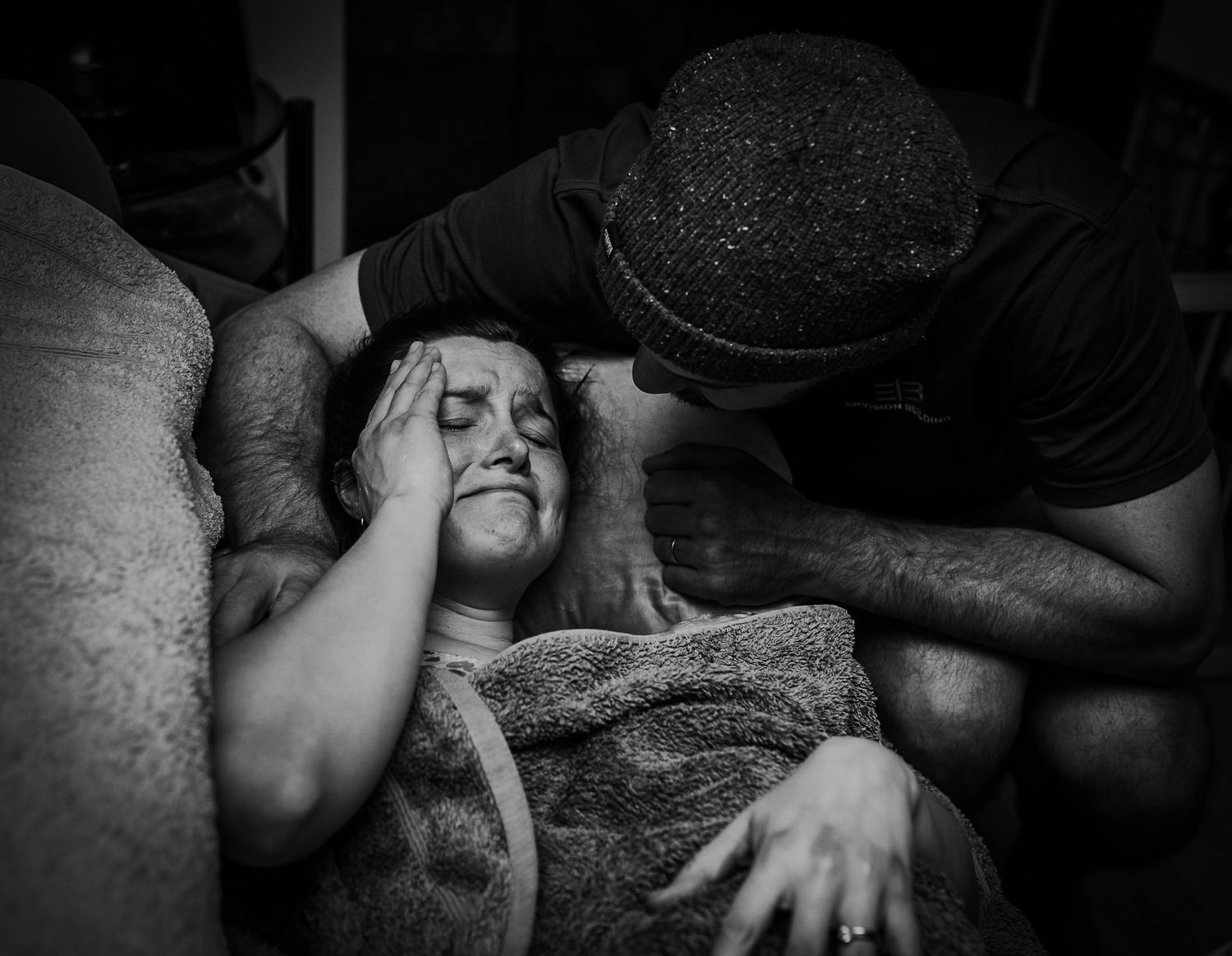 Black and white image showing intense emotional moment during labor.