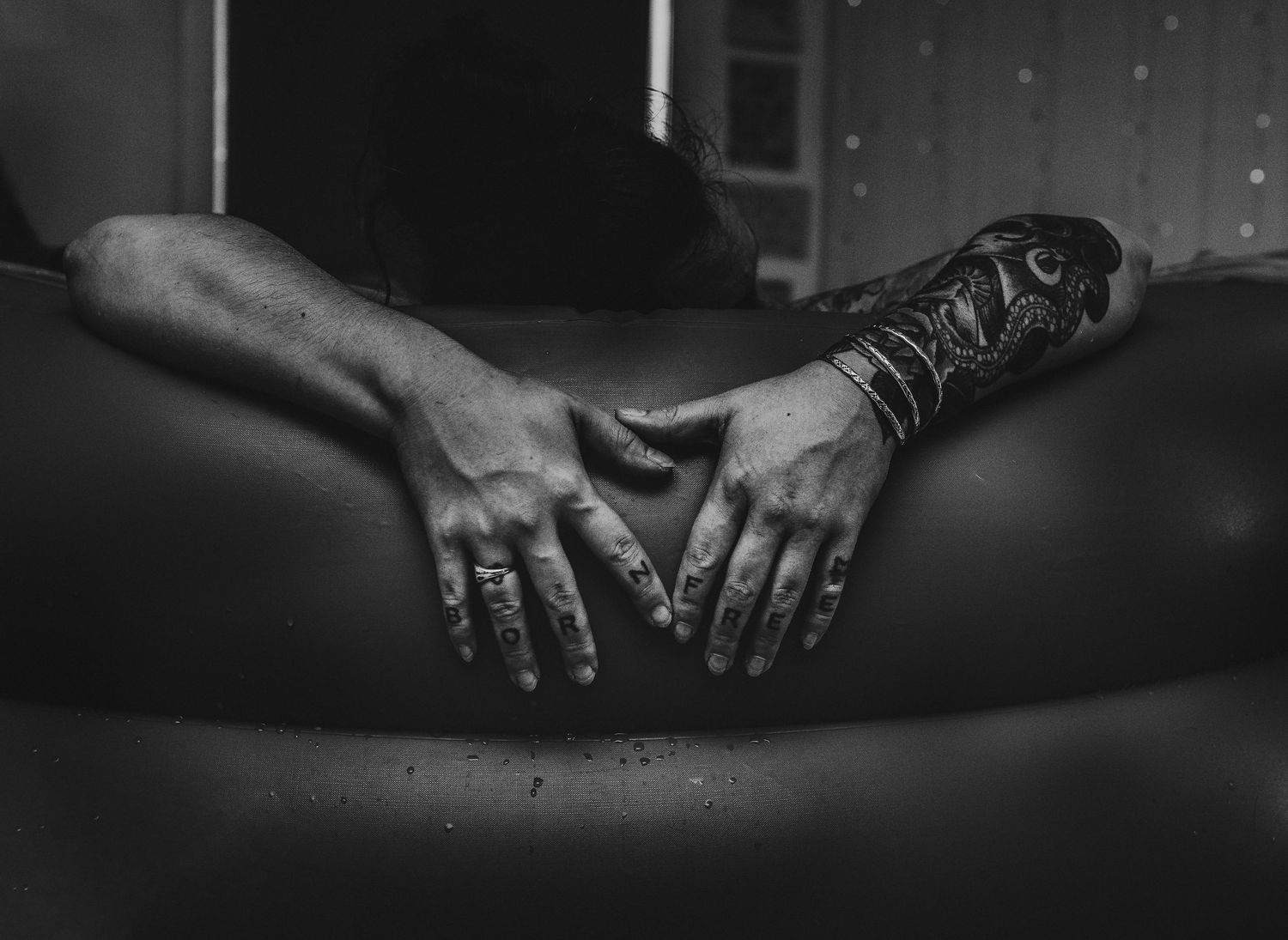 Artistic black and white close-up photography of hands in dramatic lighting.