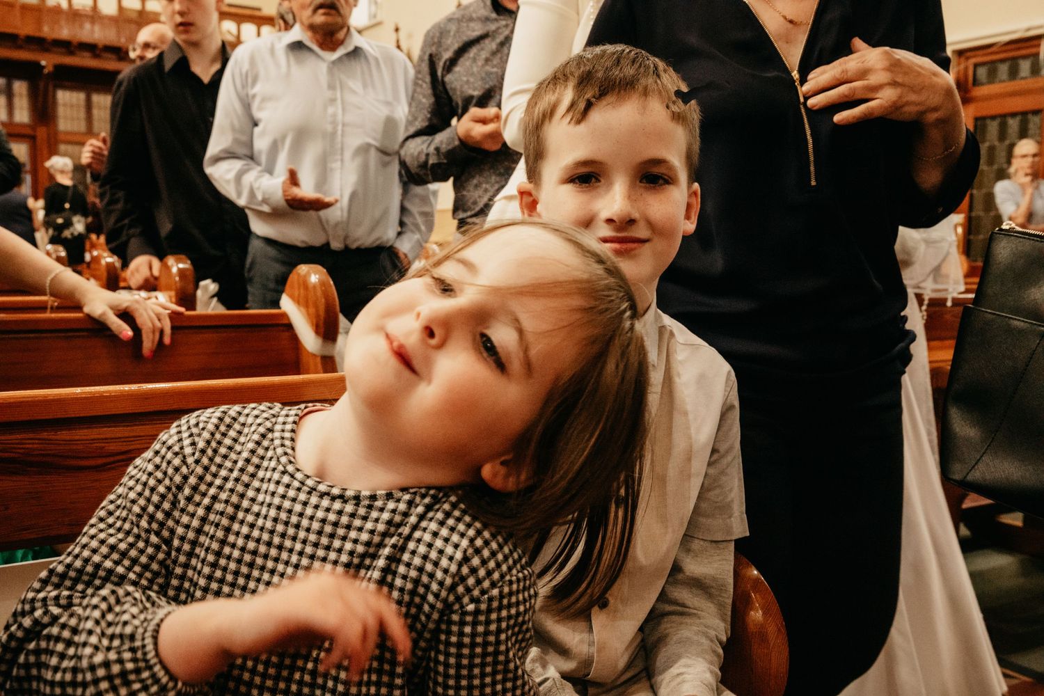 Siblings playing at communion