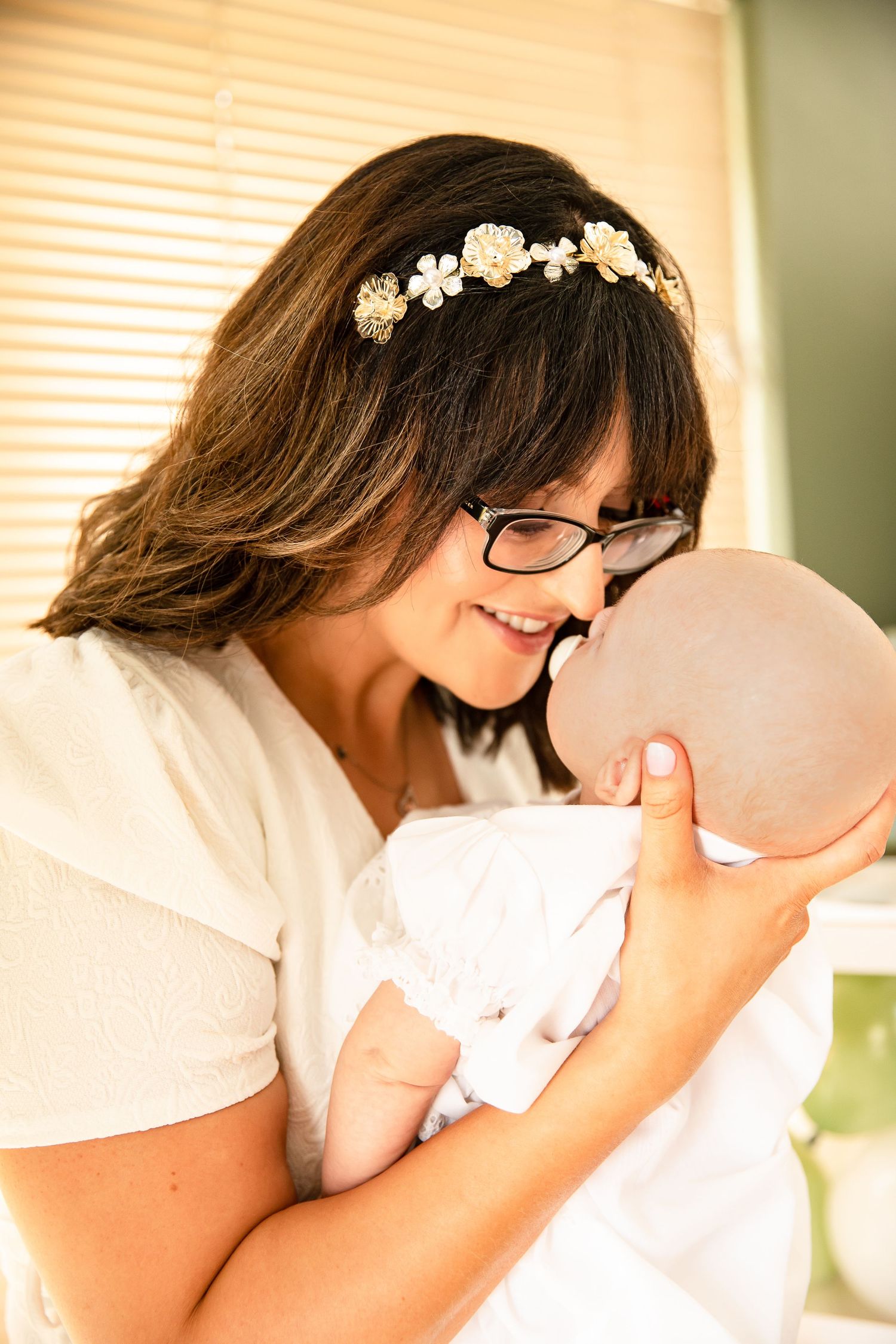 Mother holds son close at his baptism