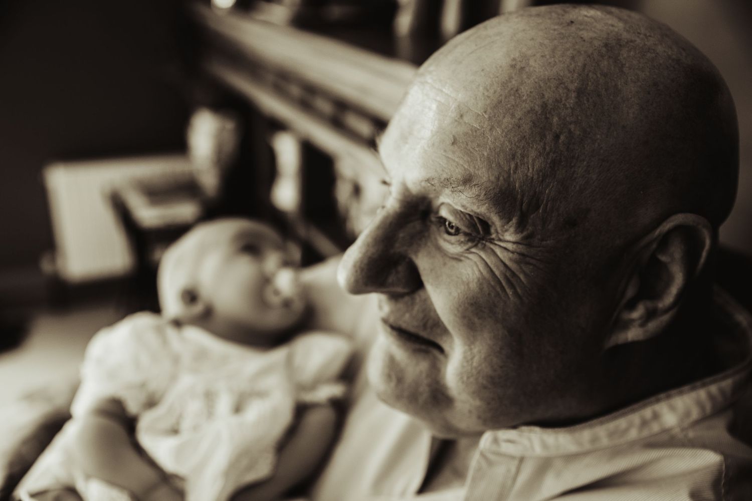 Grandfather proudly holding grandson
