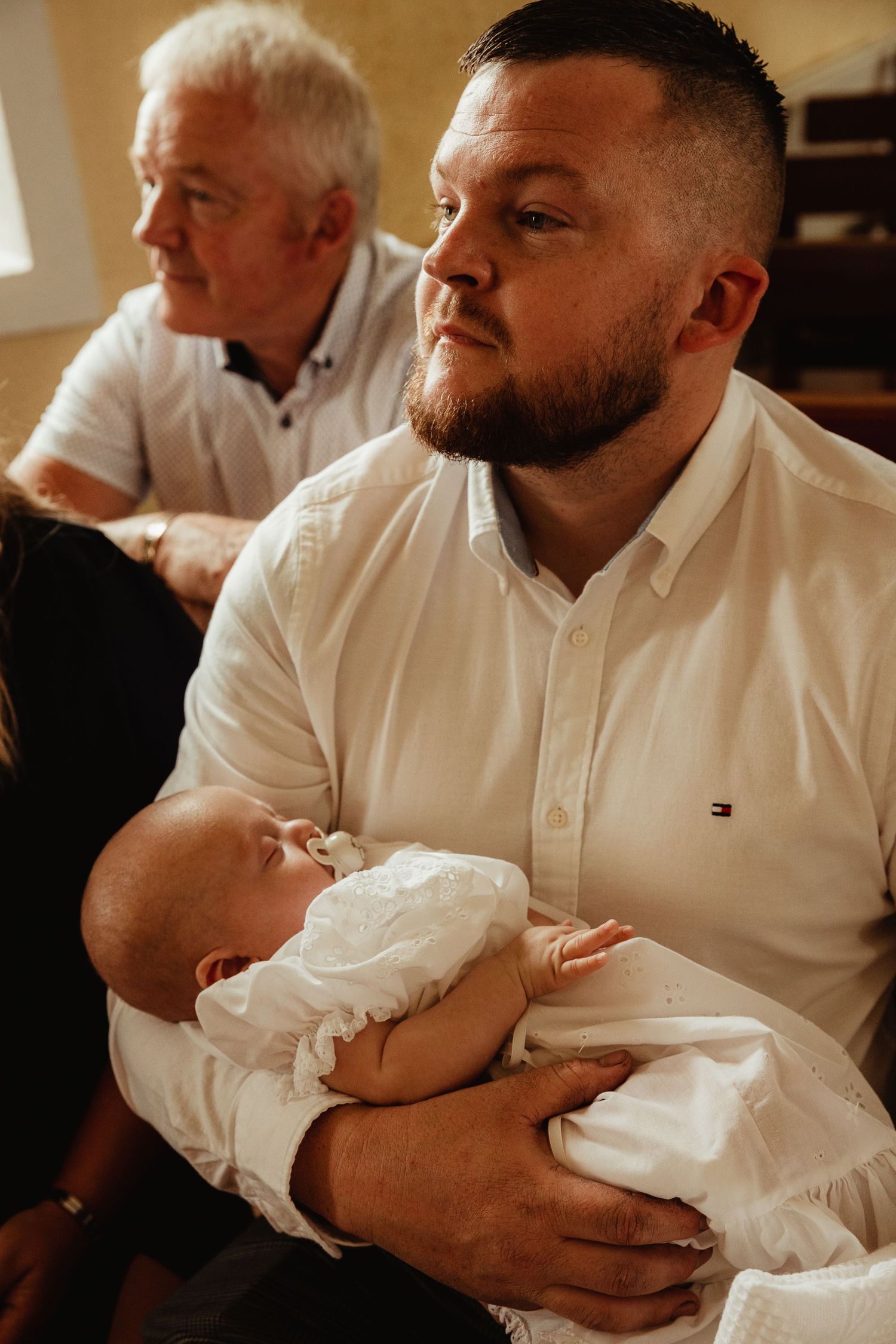 Grandfather, father and son at baptism