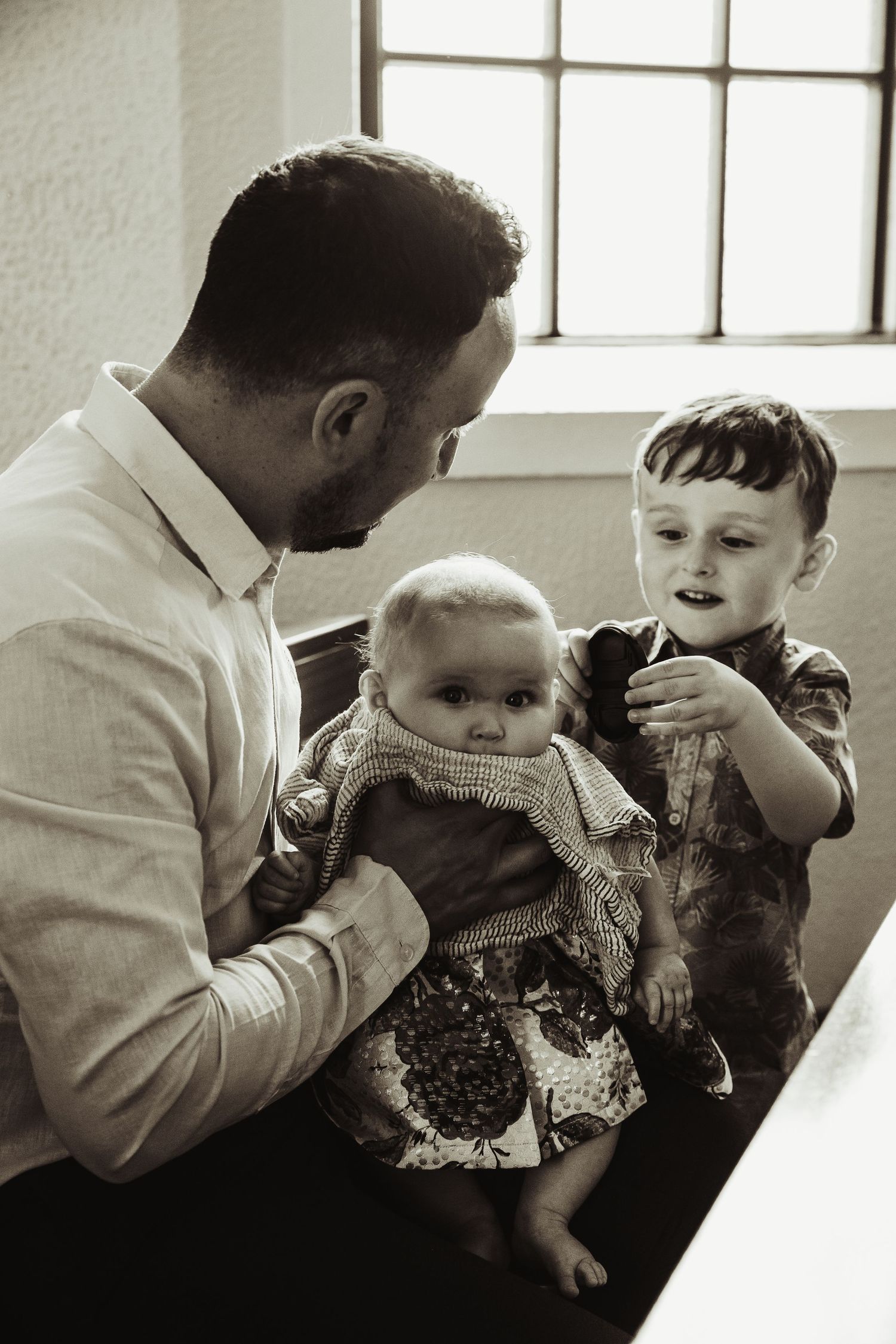 Father and two children at baptism