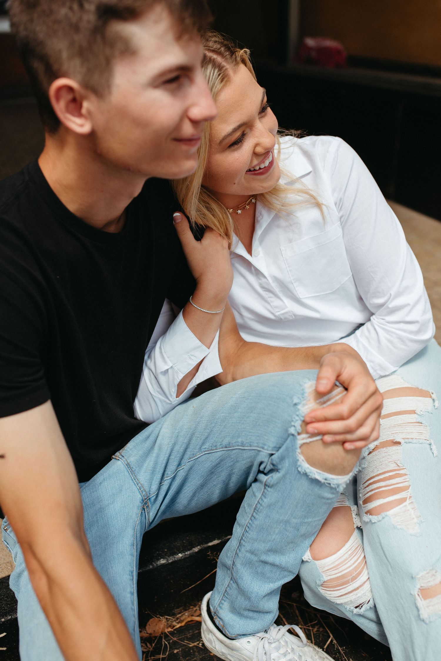 A candid moment shared between a couple wearing casual clothing.