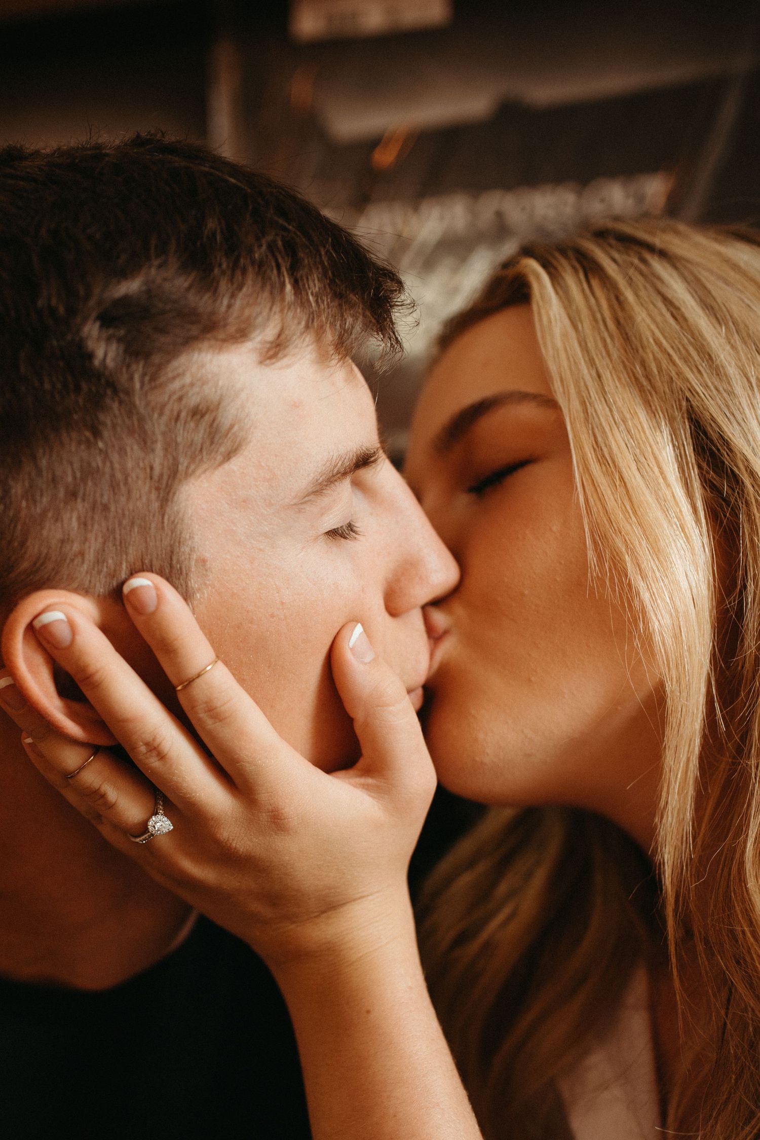 An intimate close-up of a couple sharing a romantic kiss.