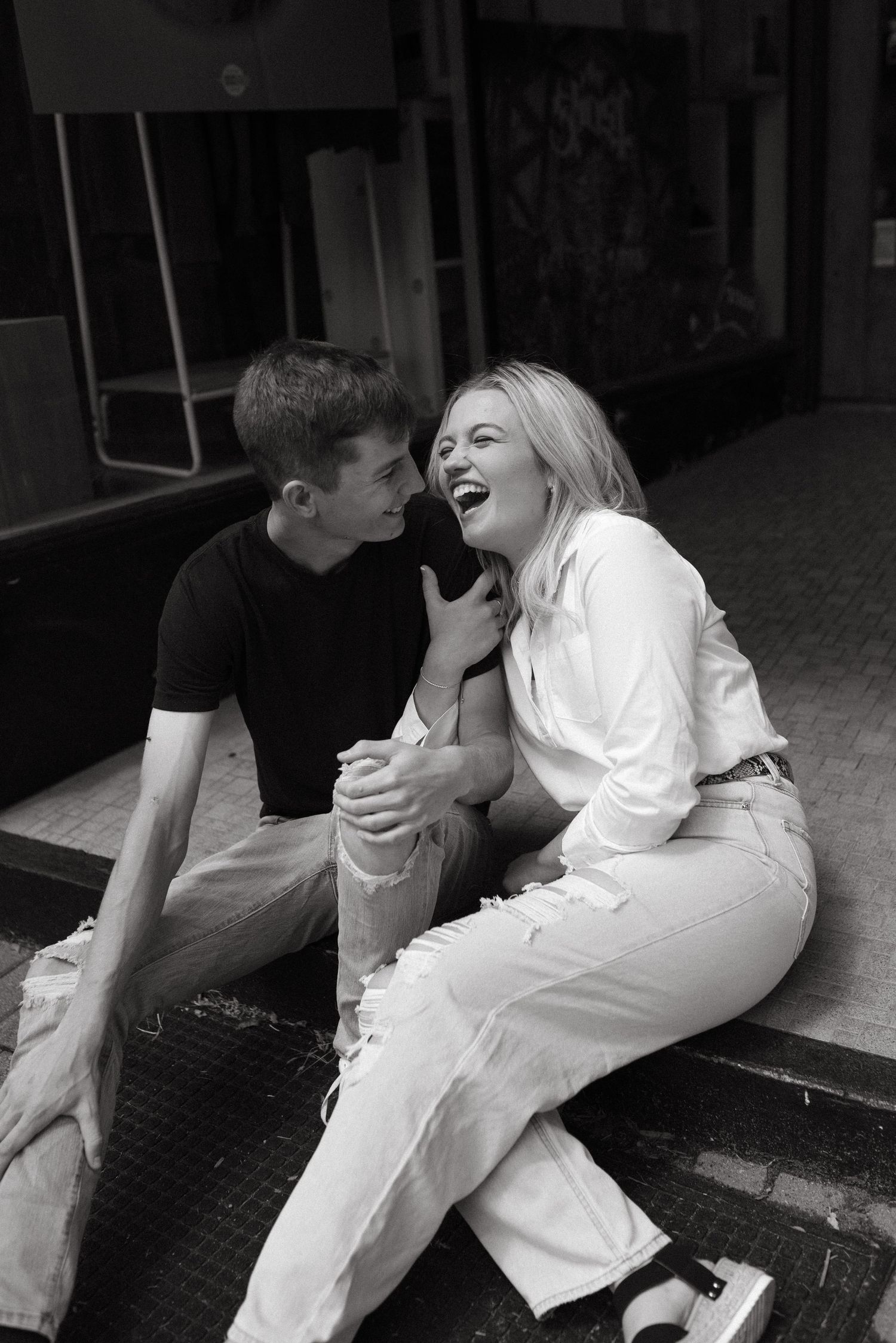 A black and white photo capturing a joyful laughing moment.