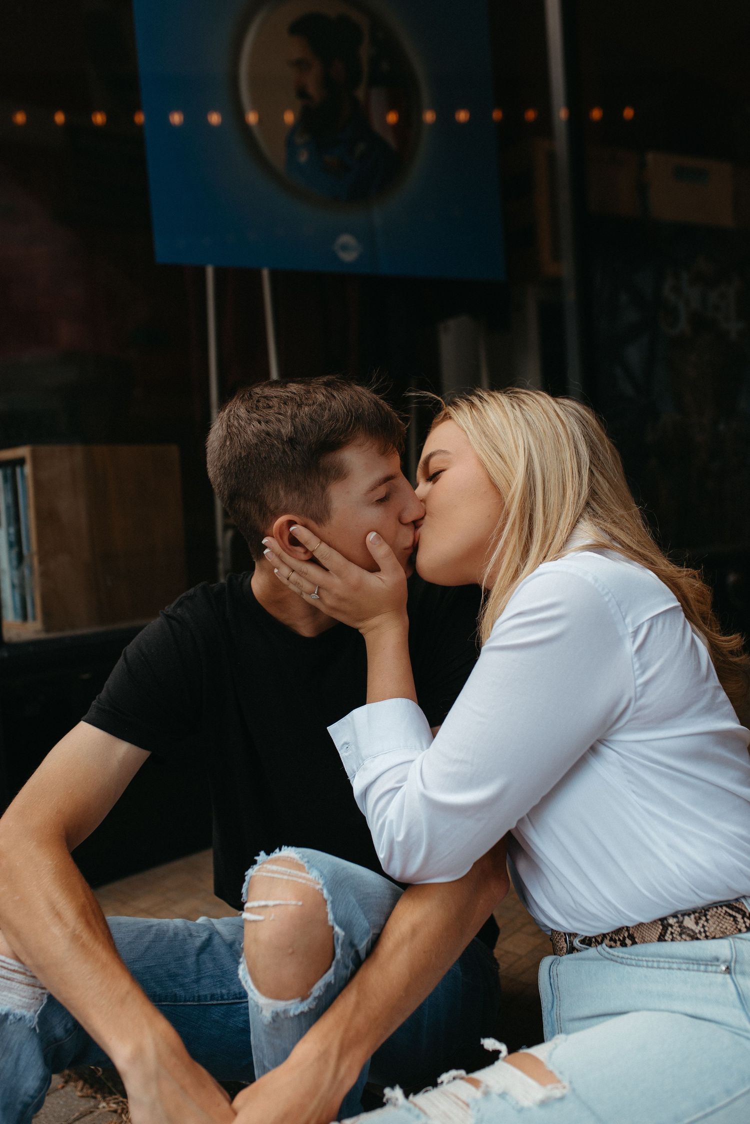 An intimate moment shared between a couple on outdoor steps.