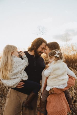 Intimate family moment captured during golden hour in a natural setting.