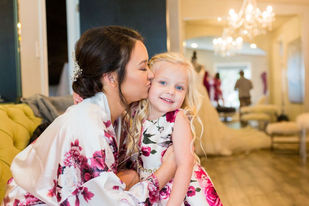 Sweet moment captured in a brightly lit room with elegant chandeliers.