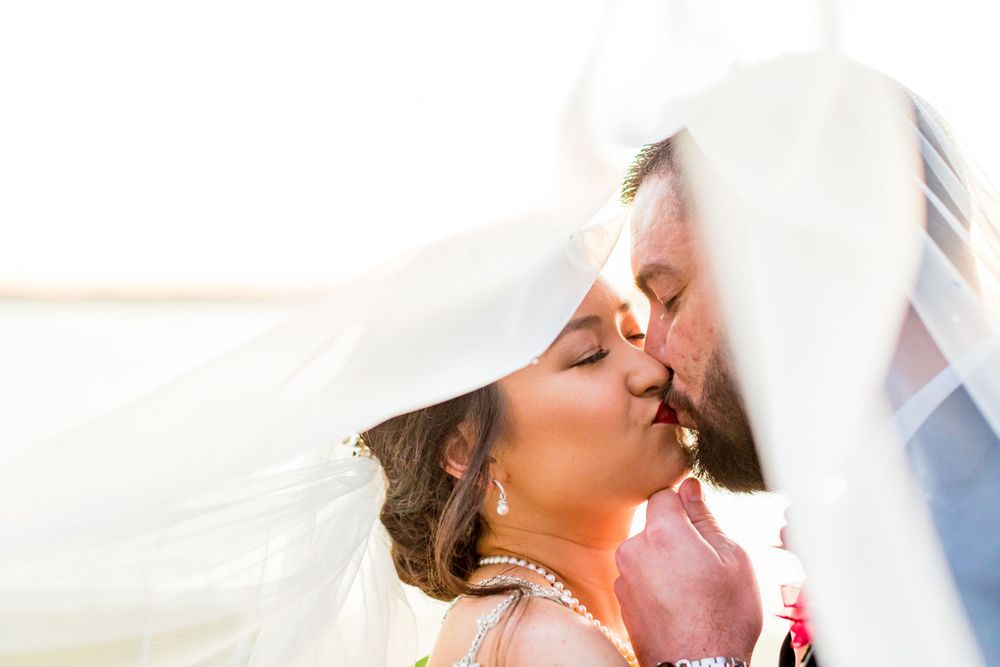 A romantic wedding veil shot with sunlight creating a dreamy effect.