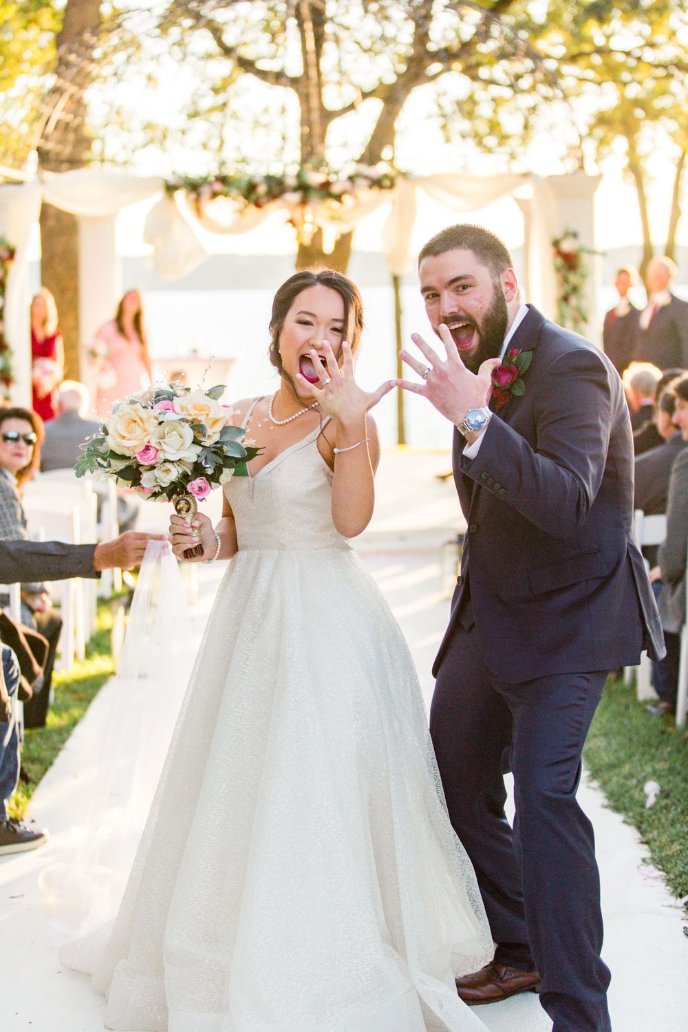 Joyful newlyweds celebrating down the aisle with candid expressions.