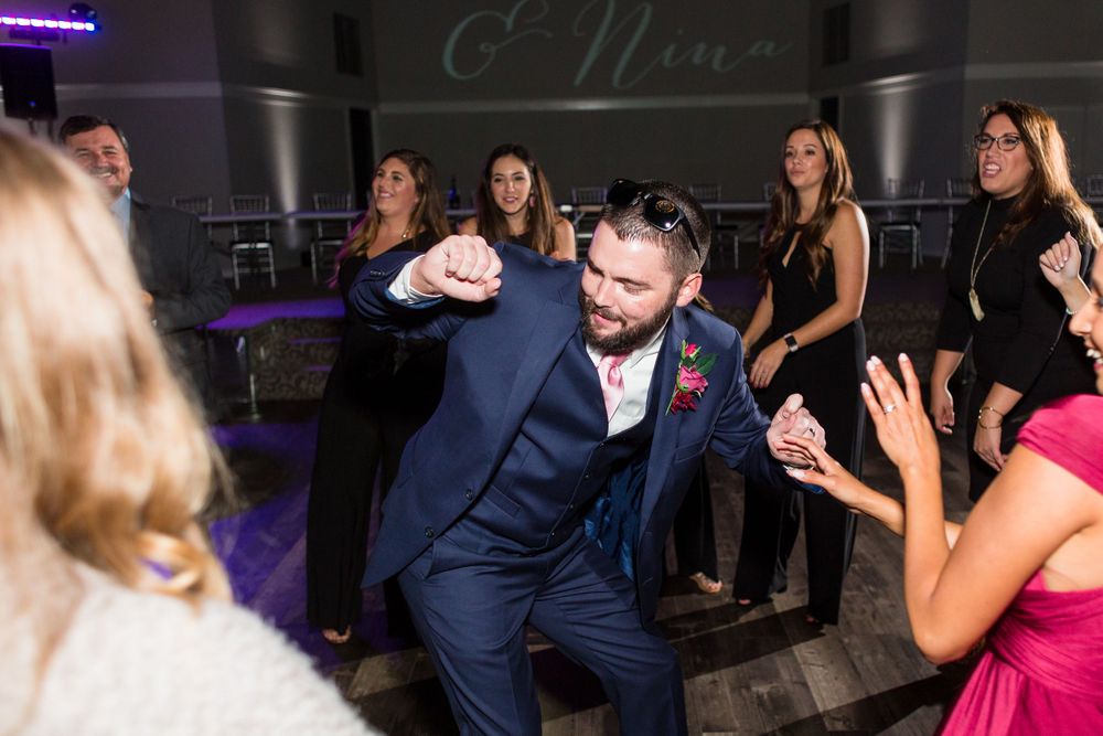 Energetic dancing and celebration during a wedding reception party.