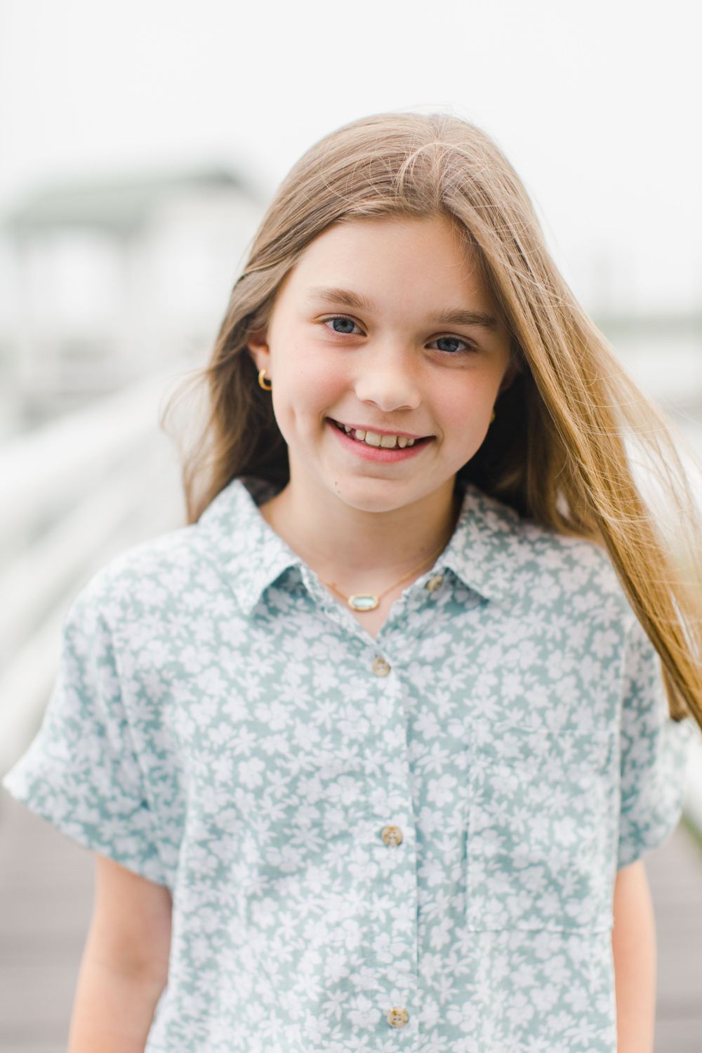 Candid portrait photography of a family in a floral print shirt smiling outdoors at Habersham in Beaufort, SC.