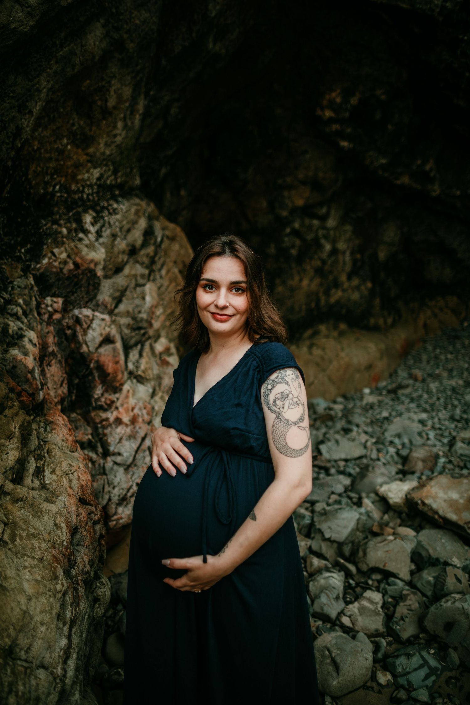 pregnant person holding belly on oregon coast maternity birth newborn photographer portland oregon