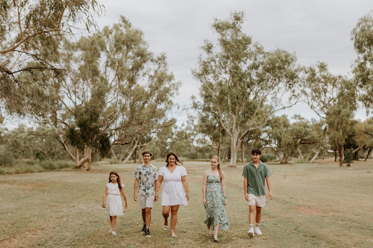 Family walking towards the camera at the park in Mount Isa