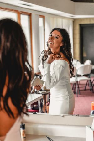 A joyful moment captured during wedding preparations in a bridal suite.